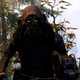 Xur stands among pine trees in Destiny 2's EDZ.